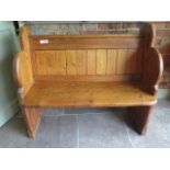 A pitch pine pew hall bench, 89cm tall x 100cm wide x 53cm deep