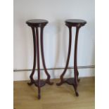 A pair of Art Noveau style jardinere stands, each with an under tier, 109cm tall, tops 29cm