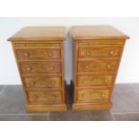 A pair of new burr oak bedside chests each with a slide above four graduating drawers, made by a
