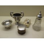 A silver trophy cup- no engraving- some small dents, a silver top glass shaker, a silver sugar bowl,