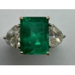 A stunning 7.3 carat Emerald and 2carat Diamond three stone gold ring, size M. Schedule description: