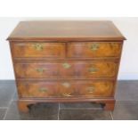 A 19th century re-veneered walnut four drawer chest with star inlaid crossbanded top and drawers