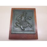 A 1930's bronze plaque by Charles Neville Bertram depicting Pan riding a tortoise. Bertram was a