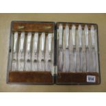 A set of six mother of pearl cake forks and knives with silver rims, one rim replaced but all good