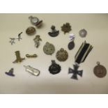Assorted military badges, a pair of Gurkha cufflinks, a German medal and a sovereign case