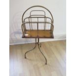 An Edwardian oak, brass and wire work magazine stand, 74cm tall, in generally good condition