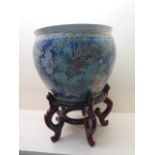 An Oriental blue ground fish bowl on stand, 50cm tall x 38cm wide, in good condition