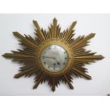 A sunburst wall clock, 8 day movement by Elliott of London, in good working order, 47cm x 33cm