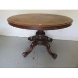 A 19th century oval tilt top table on a quatrefoil scroll base, 76cm tall x 123cm x 92cm, one scroll