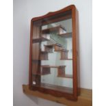 A mirror backed wall mounting display cabinet with glazed door, 77cm x 51cm x 9cm, in good condition