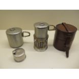 An early 1900s campaign / explorer stove and collapsible cup and pot housed in a leather case,