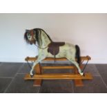A Haddon Rockers of Oxfordshire classic painted rocking horse on a pine base, 103cm tall x 138cm