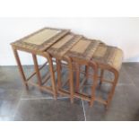 A nest of four carved hardwood Eastern side tables, 52cm tall x 51cm x 41cm