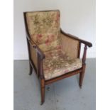 An Edwardian inlaid mahogany beregere library chair with buttoned cushions on square tapering legs
