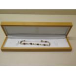 A 9ct yellow gold garnet bracelet approx 4.6 grams, marked 9ct, in good condition
