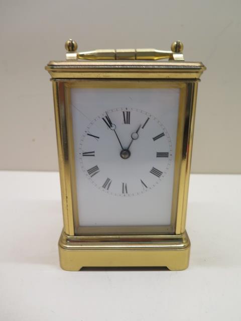 A brass French carriage clock strikes hours and half hours, 8 day movement, 15cm tall, in running