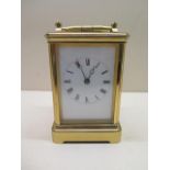 A brass French carriage clock strikes hours and half hours, 8 day movement, 15cm tall, in running