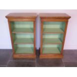 A pair of new burr oak bookcases with adjustable shelves and a painted interior made by a local