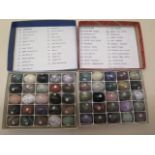 Two boxes of specimen stone eggs, each holding 25 eggs, each 2.5cm x 2cm, all in good condition