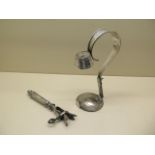 A silver plated adjustable bottle holder pourer and a meat carving clamp, both generally good some