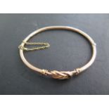 A 9ct gold bangle 6.5cm x 5.5cm external, approx 7.5 grams, clasp good, generally good condition
