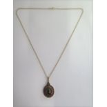 A pretty garnet three row pendant in a gilt mount marked 900 on a hallmarked 9ct chain, 44cm long,