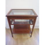 An Edwardian inlaid mahogany bijouterie display table with a drop down door, in generally good