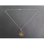 A 9ct yellow gold spider web pendant on a 9ct chain, 42cm long, pendant 25mm wide, some bending to