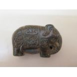 A Chinese hard stone pendant of an Asian elephant incised with an archaic dragon and symbols, 5cm