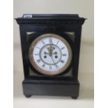 A French 8 day striking mantle clock with exposed escapement in an ebonised case, 37cm tall x 26cm