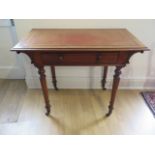 A Victorian mahogany side table with a leather inset top and a frieze drawer on turned legs, 73cm