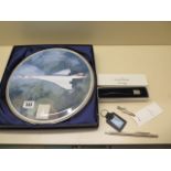 A silver Concorde letter opener, a silver Concorde tie clip, a ballpoint pen, key ring and
