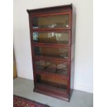 A stained beechwood five section stacking glazed Wernicke style bookcase, 180cm tall x 87cm wide x