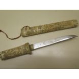 A 20th century carved bone Japanese dagger, 39cm long, generally good ,roundal missing to one end,