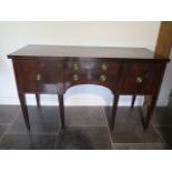 A 19th / 20th century mahogany sideboard with two central drawers, a cupboard and cellar drawer on