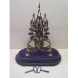 A Victorian brass cathedral skeleton clock with a chain driven fusee movement on ebonised base,