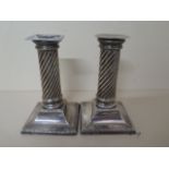 A pair of silver weighted candlesticks, Sheffield 1893/94, maker HW, 13.5cm tall, one replacement