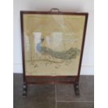 A mahogany framed silkwork Peacock fire guard, 89cm tall x 58cm wide