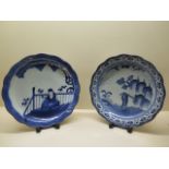 Two blue and white Oriental dishes, 30cm diameter, one has had multiple breaks and glued repair, the