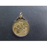A Victorian full gold sovereign dated 195, in a hallmarked 9ct mount, total weight approx 9.5 grams