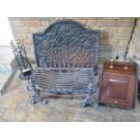 A cast iron fireback and grate with a mahogany coal scuttle and fire iron set, back 75cm x 85cm,