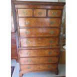 An antique style walnut chest on chest with three small drawers over six long drawers, one with a