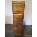 A four drawer filing cabinet, the pine drawer marked The Pre-Eminent Filing Cabinet Registered