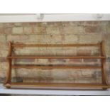 An Ercol blond elm plate rack, 49cm tall x 97cm wide x 13cm deep