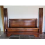 A modern mahogany 6' sleigh bed with a two piece MDF board base