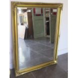 A modern ornate gilt mirror, 88cm x 116cm