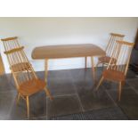 An Ercol dining table and 4 high back Ercol dining chairs in generally good condition apart from a