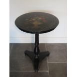 A Victorian flower and urn decorated ebonised tilt top side table, 67cm tall x 50cm diameter