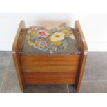 An Art Deco walnut stool with lift up needlepoint seat, 49cm tall x 50cm wide x 44cm deep