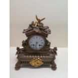 An ormulu striking mantle clock, 27cm tall x 24cm, running and strikes, some cracking to dial but